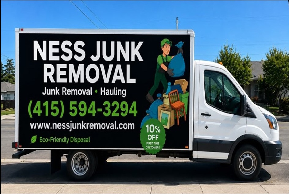 Ness Junk Removal crew loading boxes into the truck in a driveway